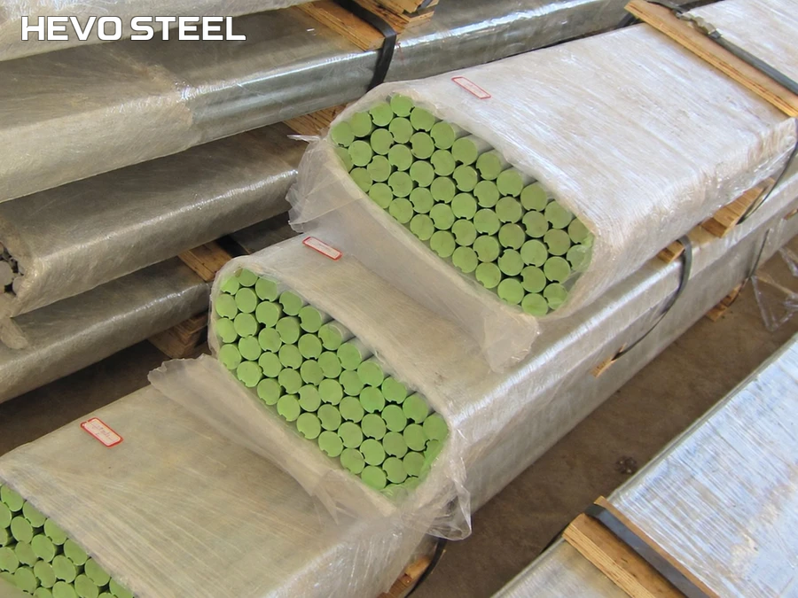 Wrapped bundles of solid rod stock with green end markings and timber supports.